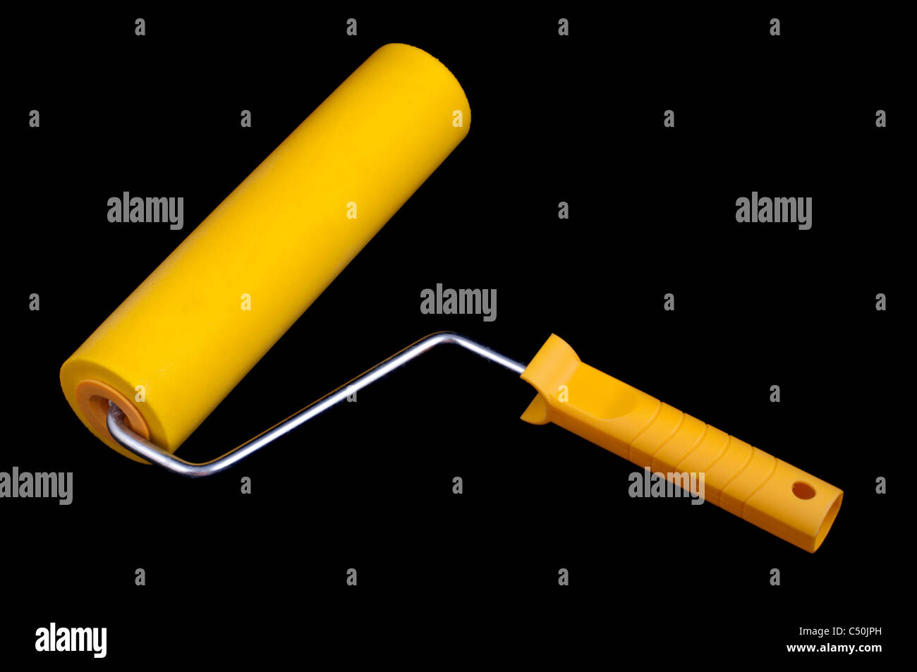 Yellow paint roller, isolated on black background Stock Photo