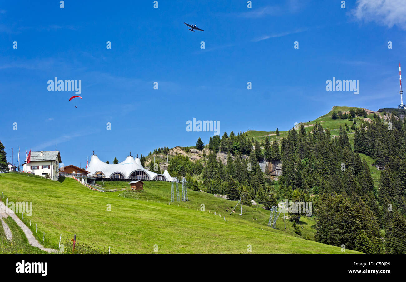 Railway station at Staffel on Rigi Mountain Switzerland with Rigi Event Tent and Rigi Kulm to the right & aeroplane and glider Stock Photo