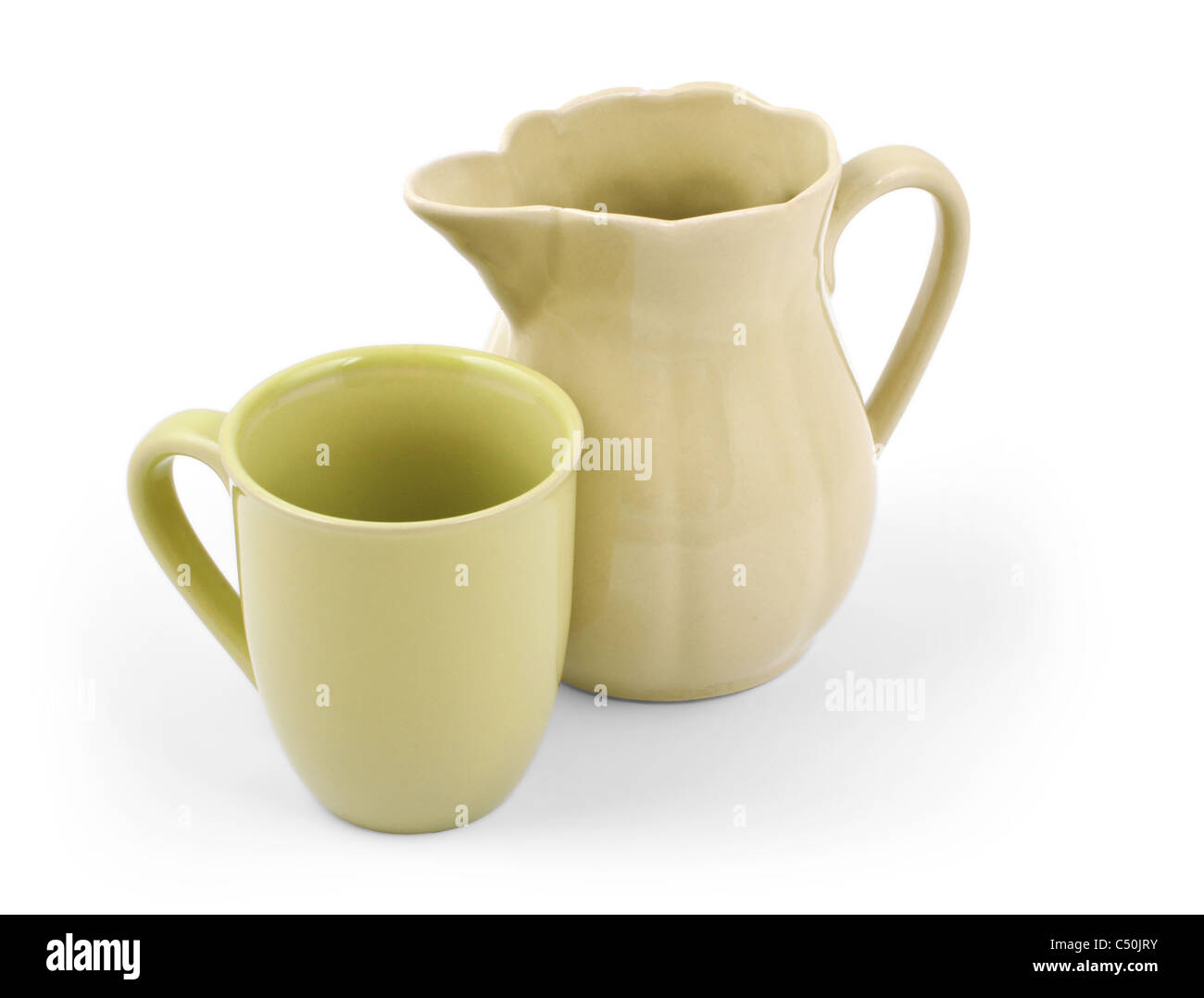 Old green ceramic pitcher and cup isolated on white background Stock Photo