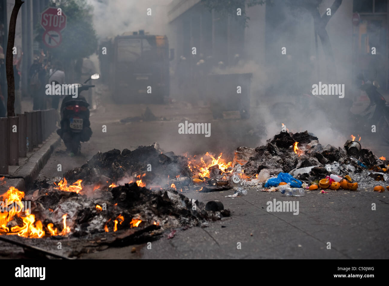 Burning barricade in Nikis street off Syntagma square during the violent clashes between riot police and protesters Stock Photo