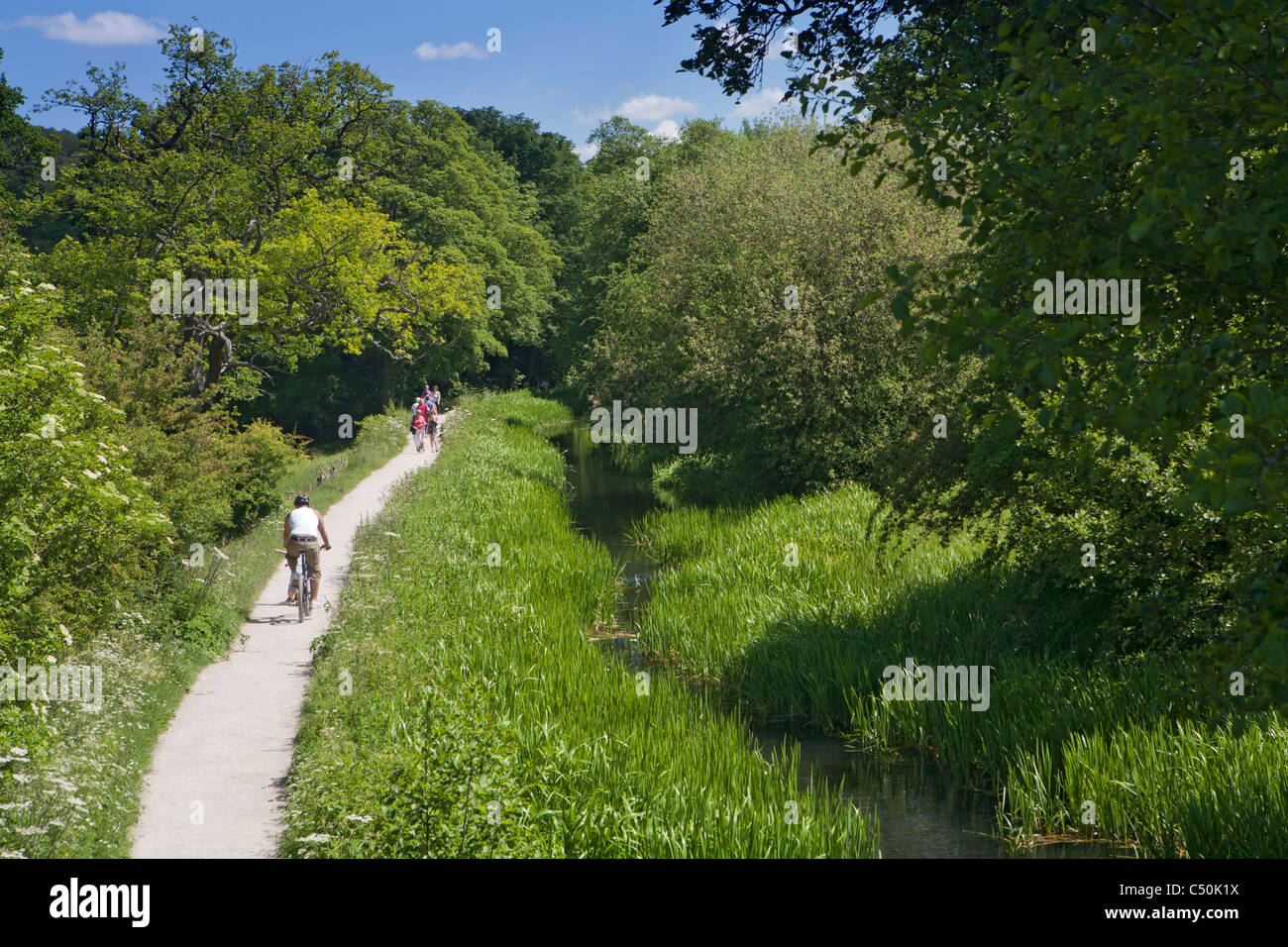 Walkers on the Cromford Canal towpath, Cromford, Derbyshire, England UK Stock Photo