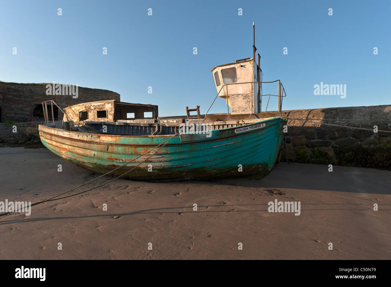 Old boats on the beach at Beadnell. Stock Photo
