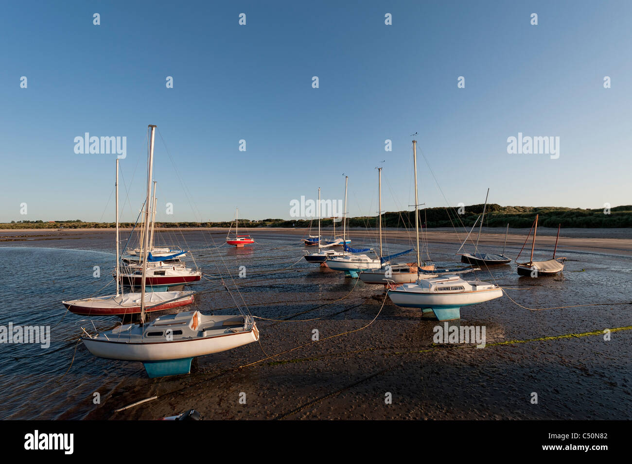Yachts on the beach at Beadnell. Stock Photo