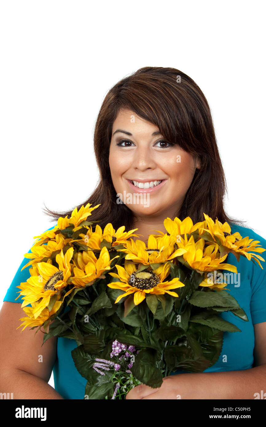 This young smiling hispanic woman looks totally and completely pleased with this bouquet of sunflowers. Stock Photo