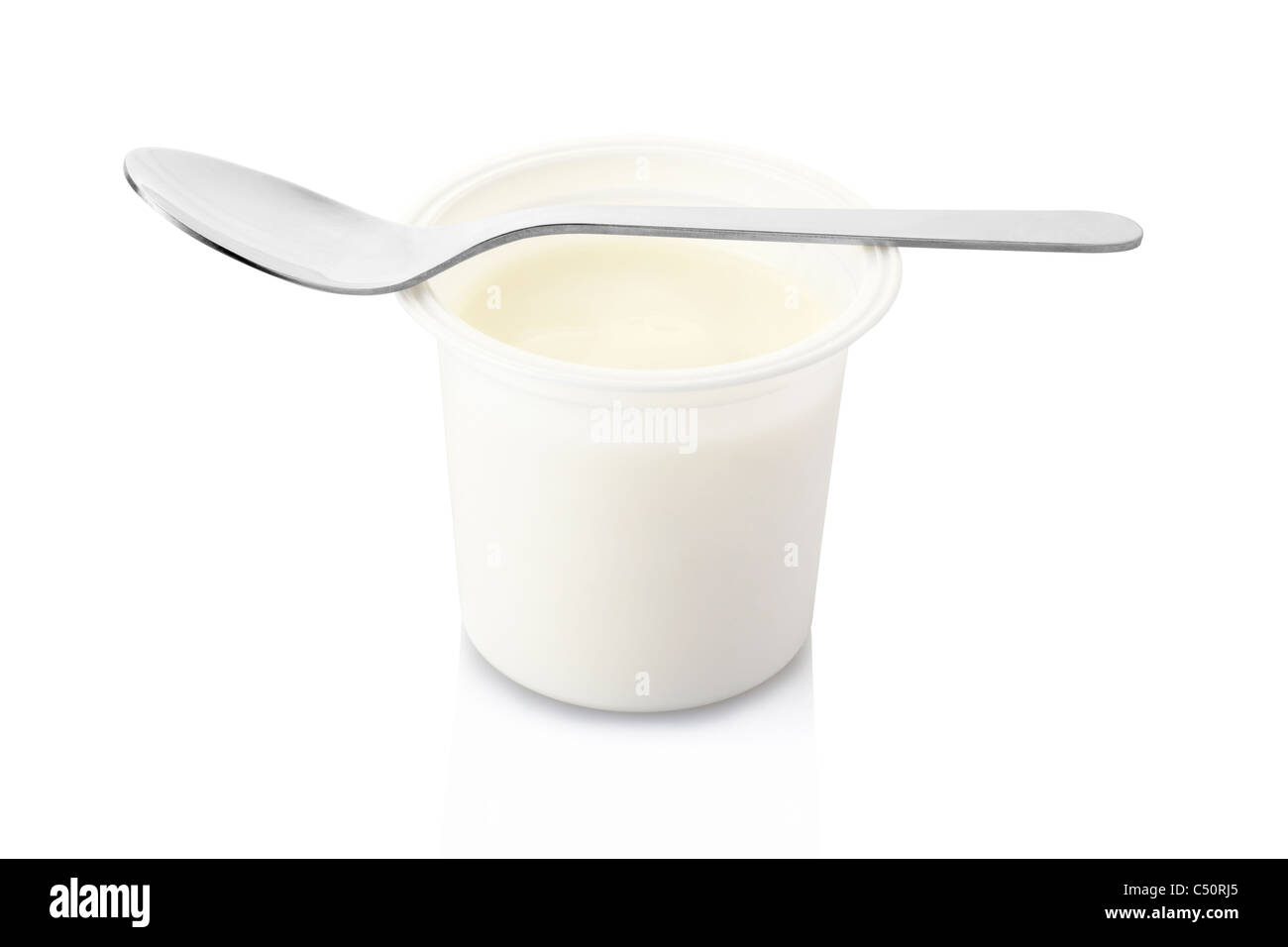 Yogurt pot and spoon Stock Photo