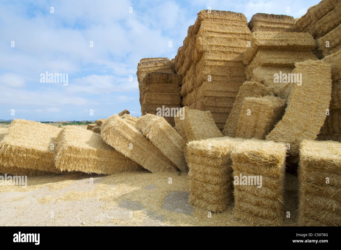 Straw bales on farmland with cloudy sky Stock Photo - Alamy