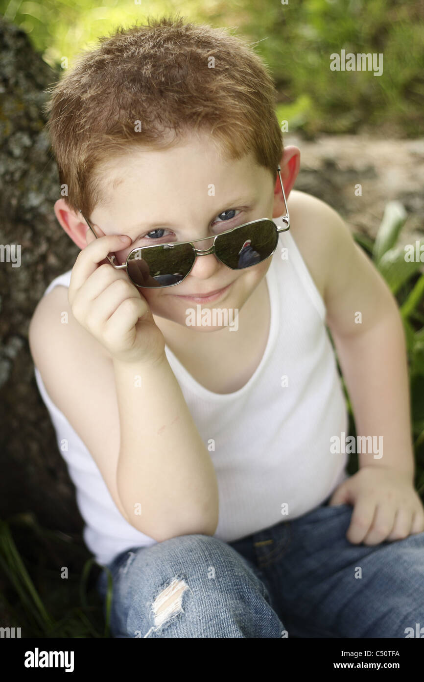 Cool 3 year old with his sunglasses and ripped jeans. Stock Photo