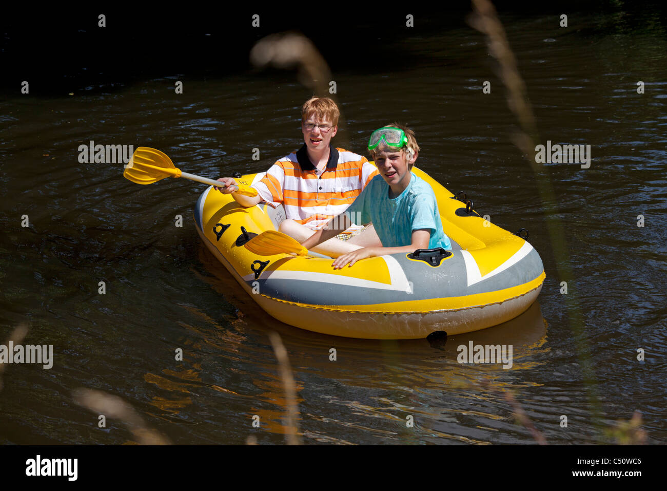 two young boys in a rubber boat Stock Photo Alamy
