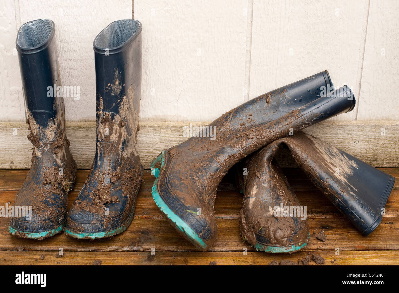 Muddy boots on deck after working in garden Stock Photo - Alamy