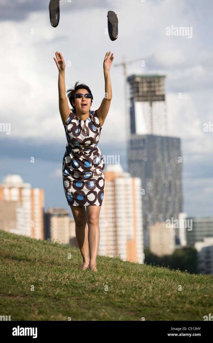 Woman throwing her shoes into the air Stock Photo - Alamy