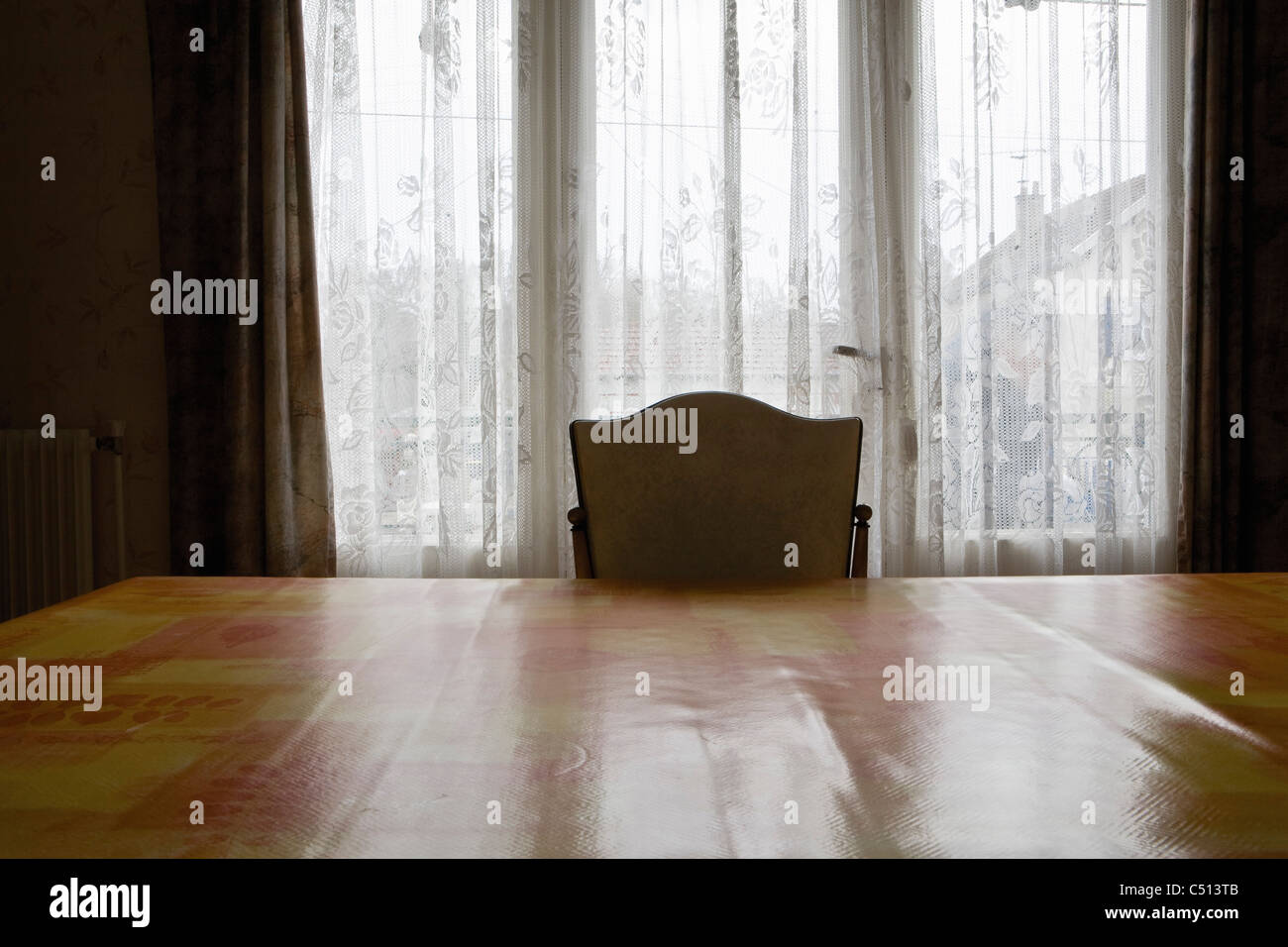 Empty chair at table Stock Photo - Alamy