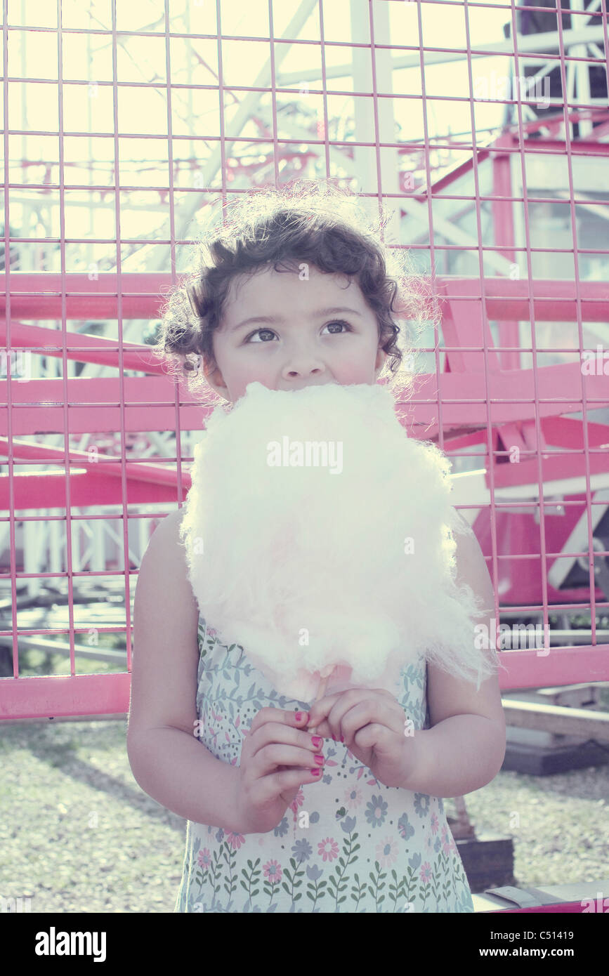 Little girl eating cotton candy Stock Photo Alamy