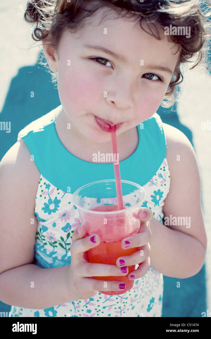 Little girl drinking juice, portrait Stock Photo