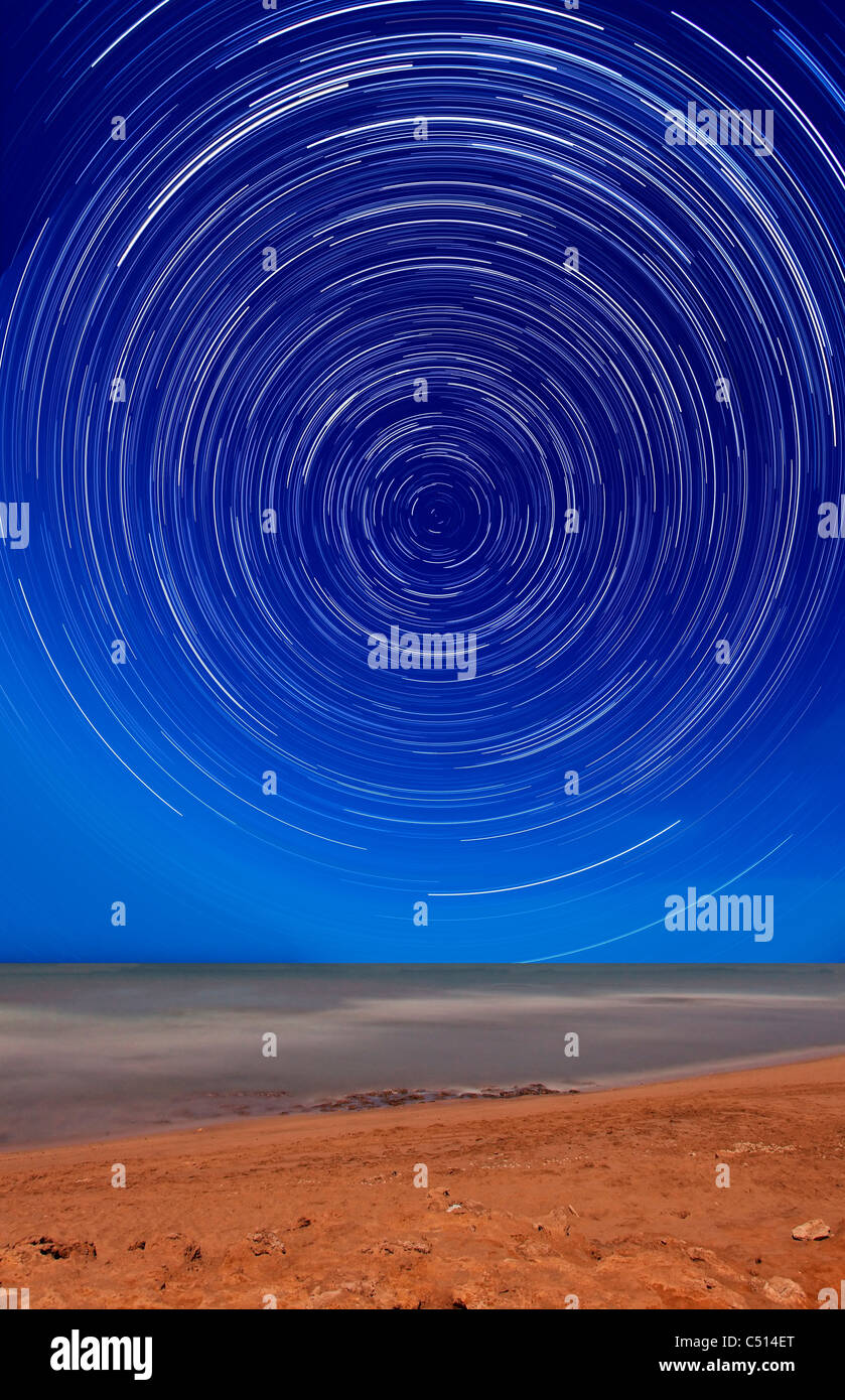 Star trails around the south celestial pole at the beach in Miramar, Argentina. Stock Photo
