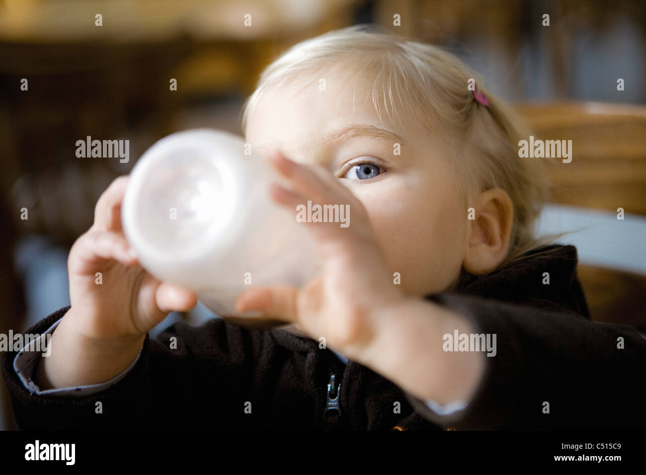 Baby girl drinking from baby bottle Stock Photo Alamy