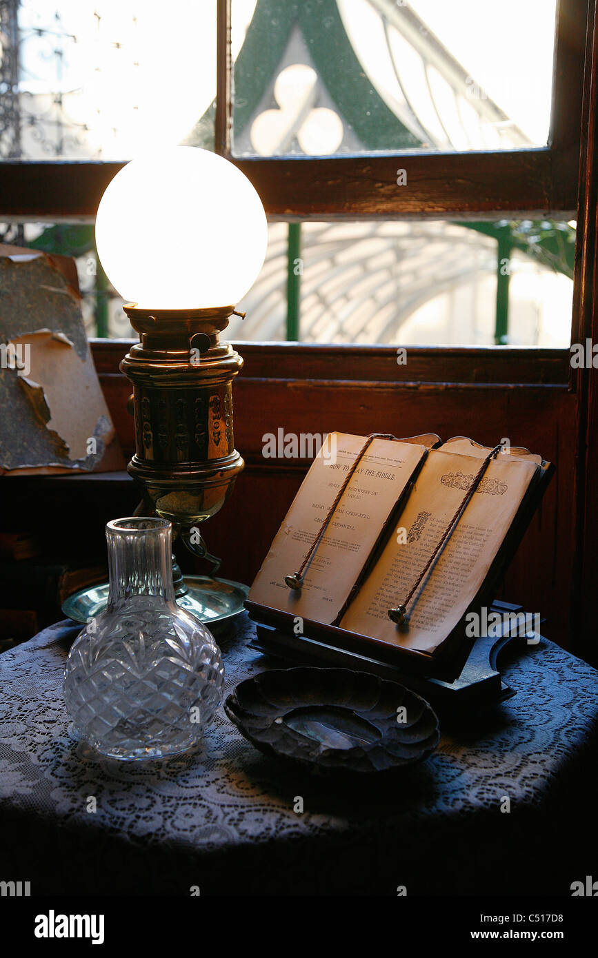Open book on book stand by illuminated lamp Stock Photo Alamy