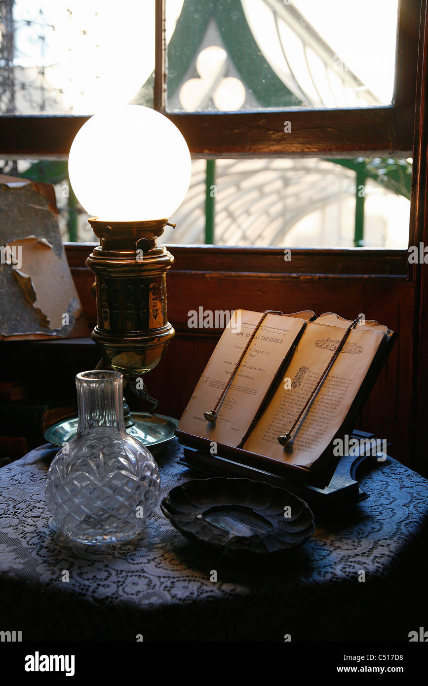Open book on book stand by illuminated lamp Stock Photo