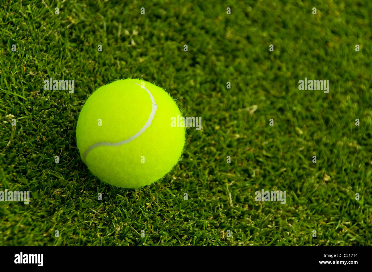 A tennis ball on a lawn court Stock Photo Alamy
