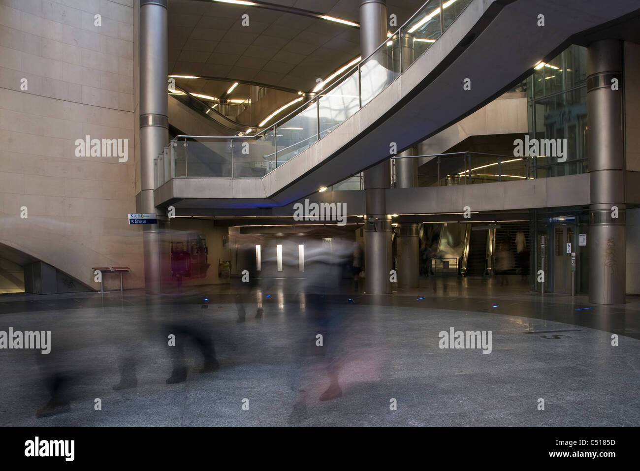 People walking through building atrium, blurred motion Stock Photo