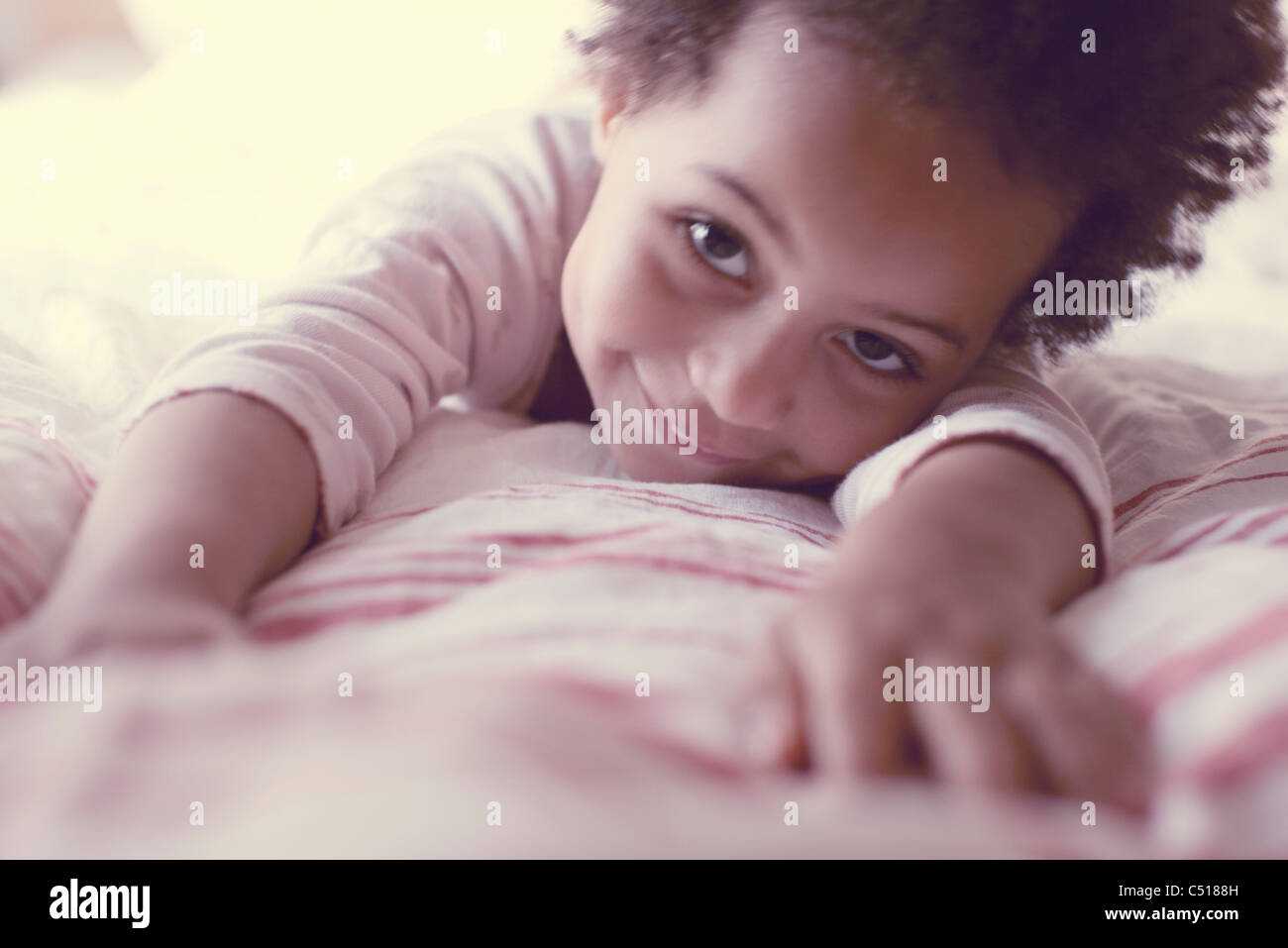 Little girl lying on stomach Stock Photo Alamy