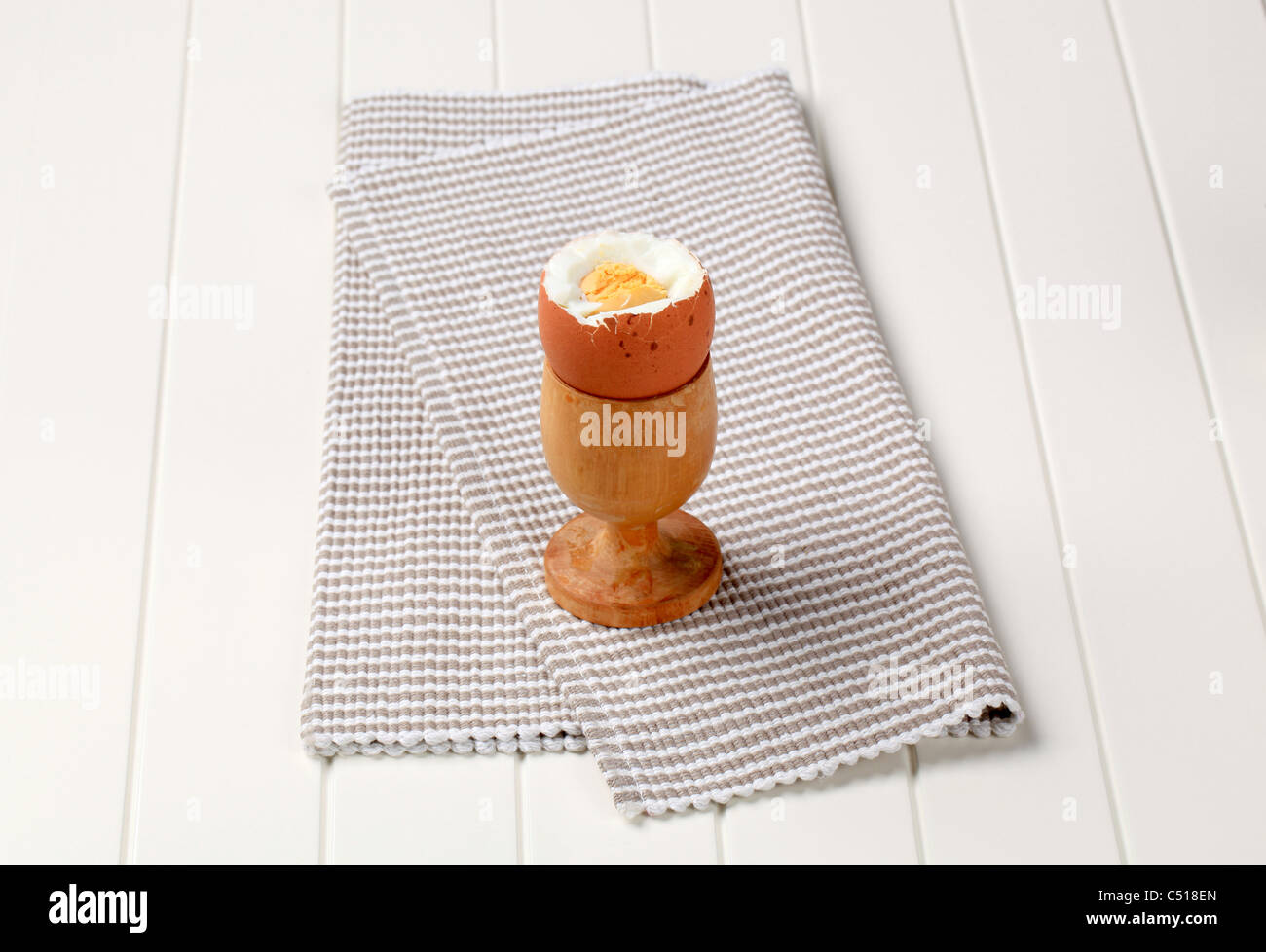 Boiled egg in a wooden eggcup Stock Photo