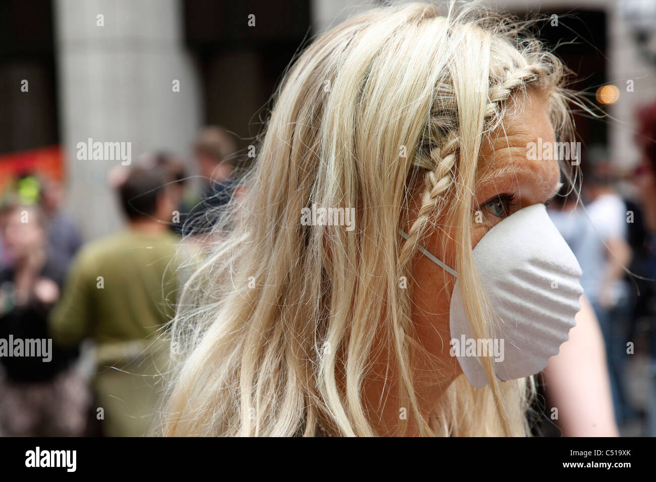 Woman wearing face mask demonstrating against Chemtrails Stock Photo -