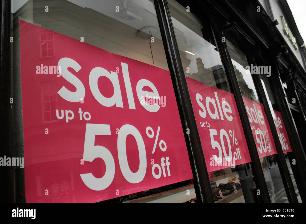 Sale signs in shop window Stock Photo Alamy