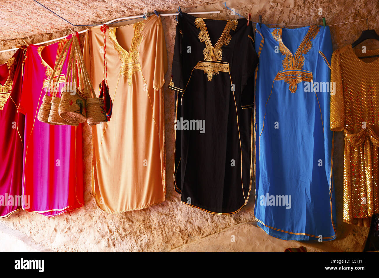 Africa, Tunisia, Tamerza Oasis, Stall Displaying Local Cloths and Dresses Stock Photo
