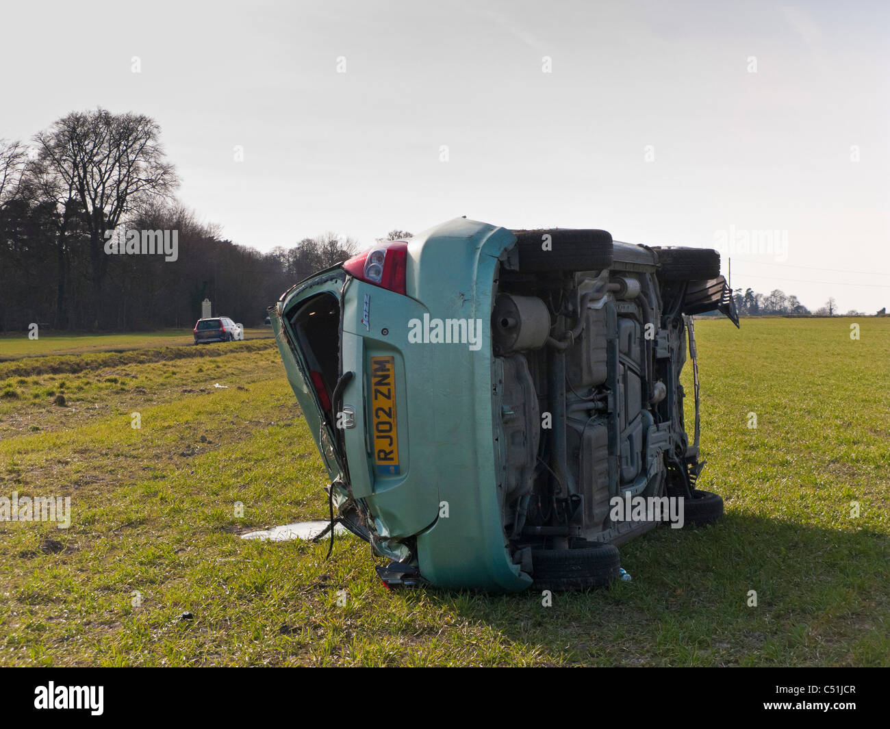 Honda Jazz car accident wrecked rolled in field. JMH5089 Stock Photo