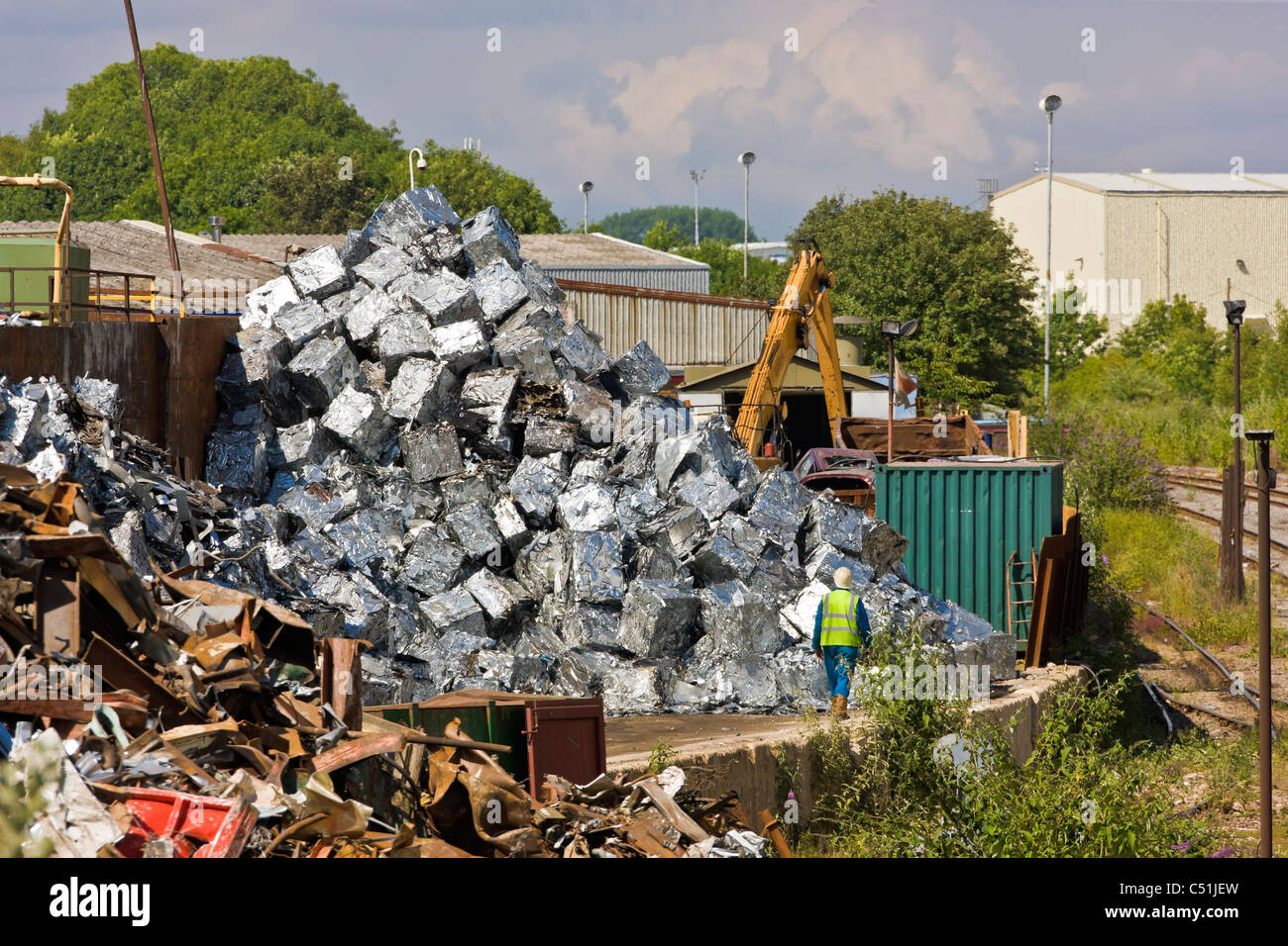 Unwanted old cars scrapped and crushed into cubes at recycling