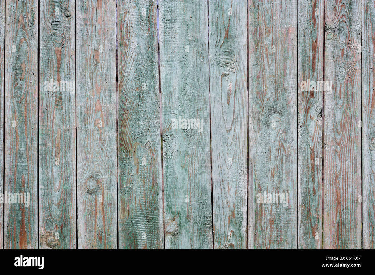 A fragment of an old, painted in green, wooden fence Stock Photo - Alamy