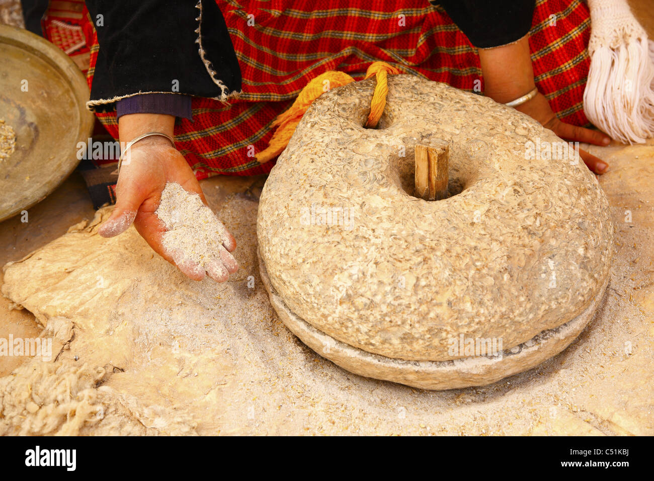Africa, North Africa, Tunisia, Matmata, Troglodyte Pit Home, Berber Woman Grinding Grain Stock Photo