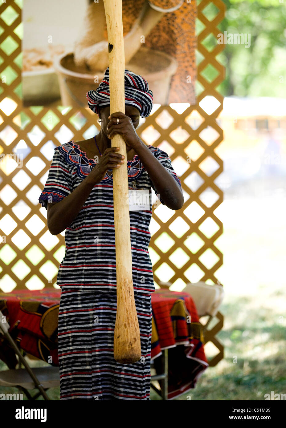 An African woman pounding grain Stock Photo