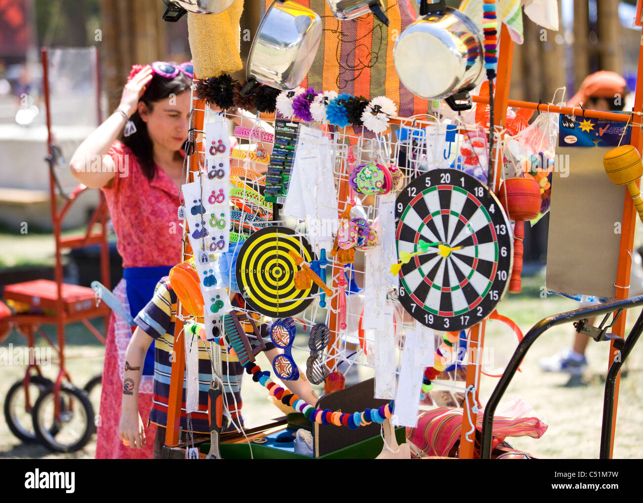 A South American woman selling household goods, accessories, and toys from a cart Stock Photo