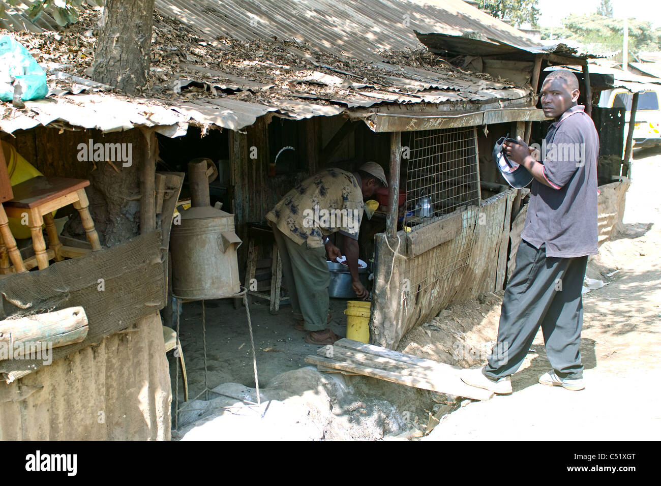 Looking into hut where food is being prepared in Nairobi slum area. Stock Photo