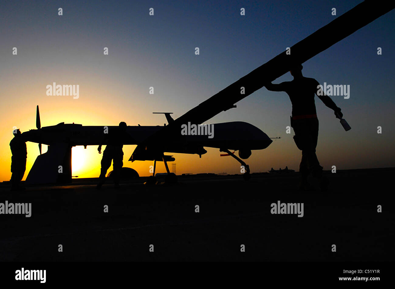 Airman pre-flight an MQ-1 Predator unmanned aerial vehicle at Ali Base, Iraq. Stock Photo