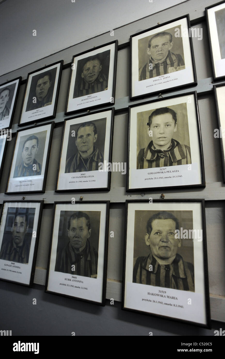 Auschwitz 1 former concentration camp and now a State Museum - Photographs of female victims line the walls of prisoner block Stock Photo
