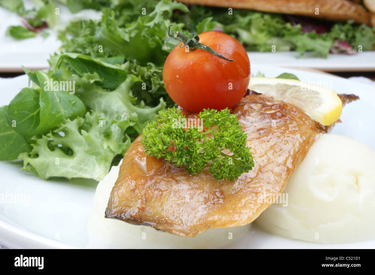 smoked mackerel fillet with tomato on mash potato Stock Photo Alamy