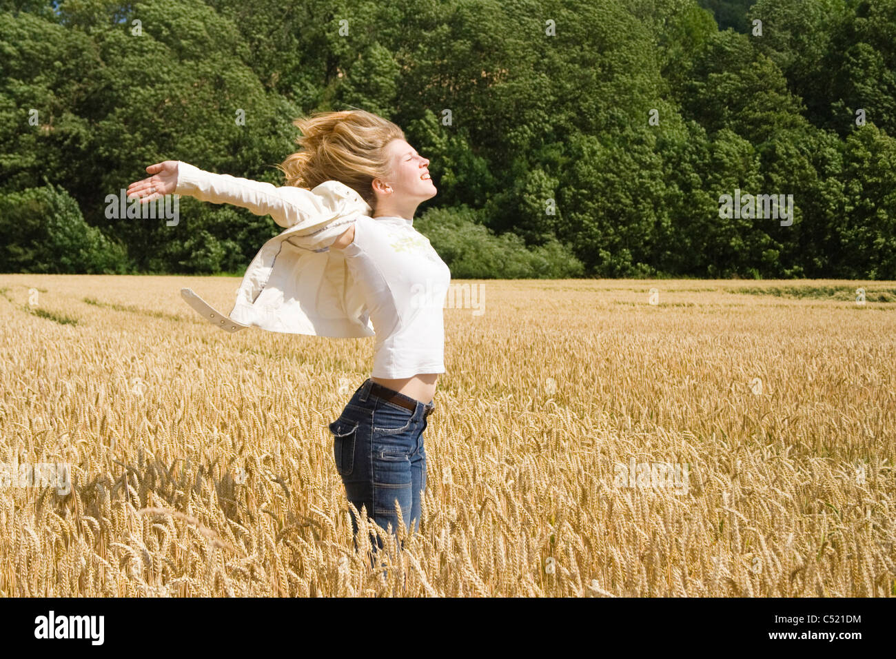 Woman Standing In The Middle Of A Grain Field Stock Photo Alamy