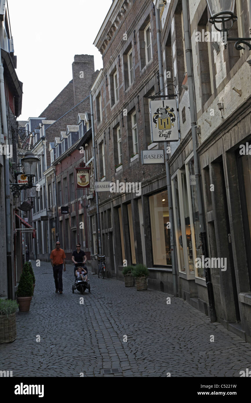 People walking down a street in the historic city centre of Maastricht Stock Photo