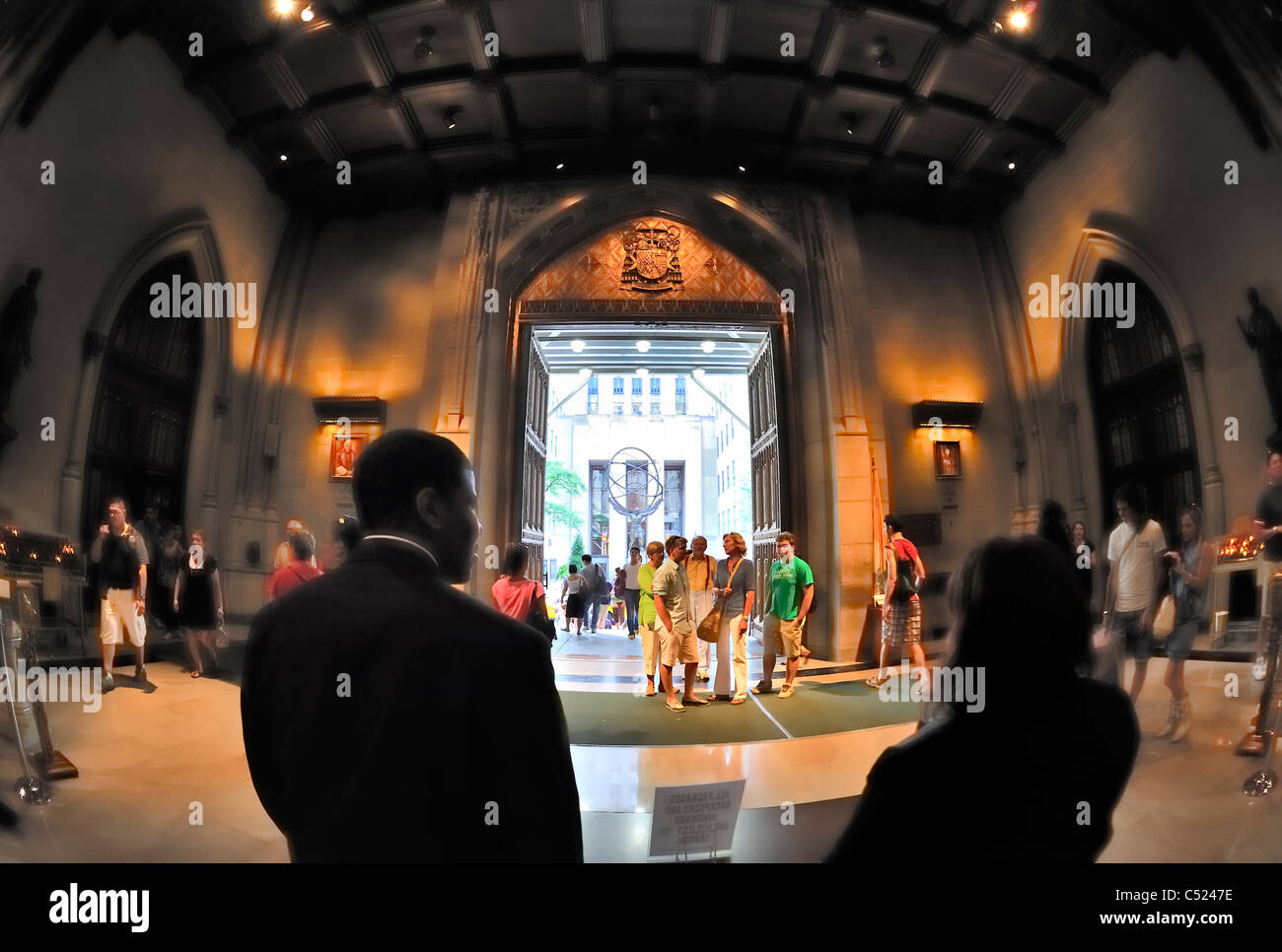 Inside St. Patrick's Cathedral lobby looking out to statue of Atlas, 5th Avenue, NYC, New York, USA, 2011 (fisheye lens view) Stock Photo