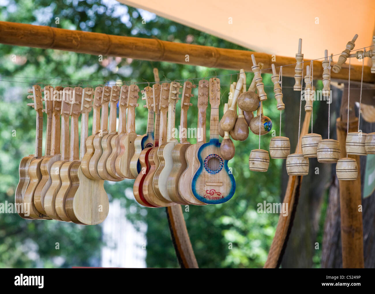 Handmade wooden musical instruments and toys hang on a wire Stock Photo