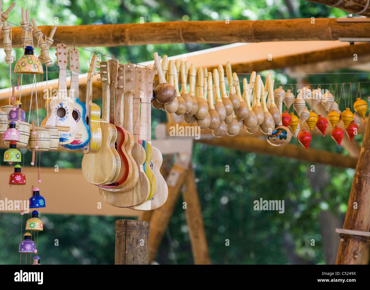 Handmade wooden musical instruments and toys hang on a wire Stock Photo