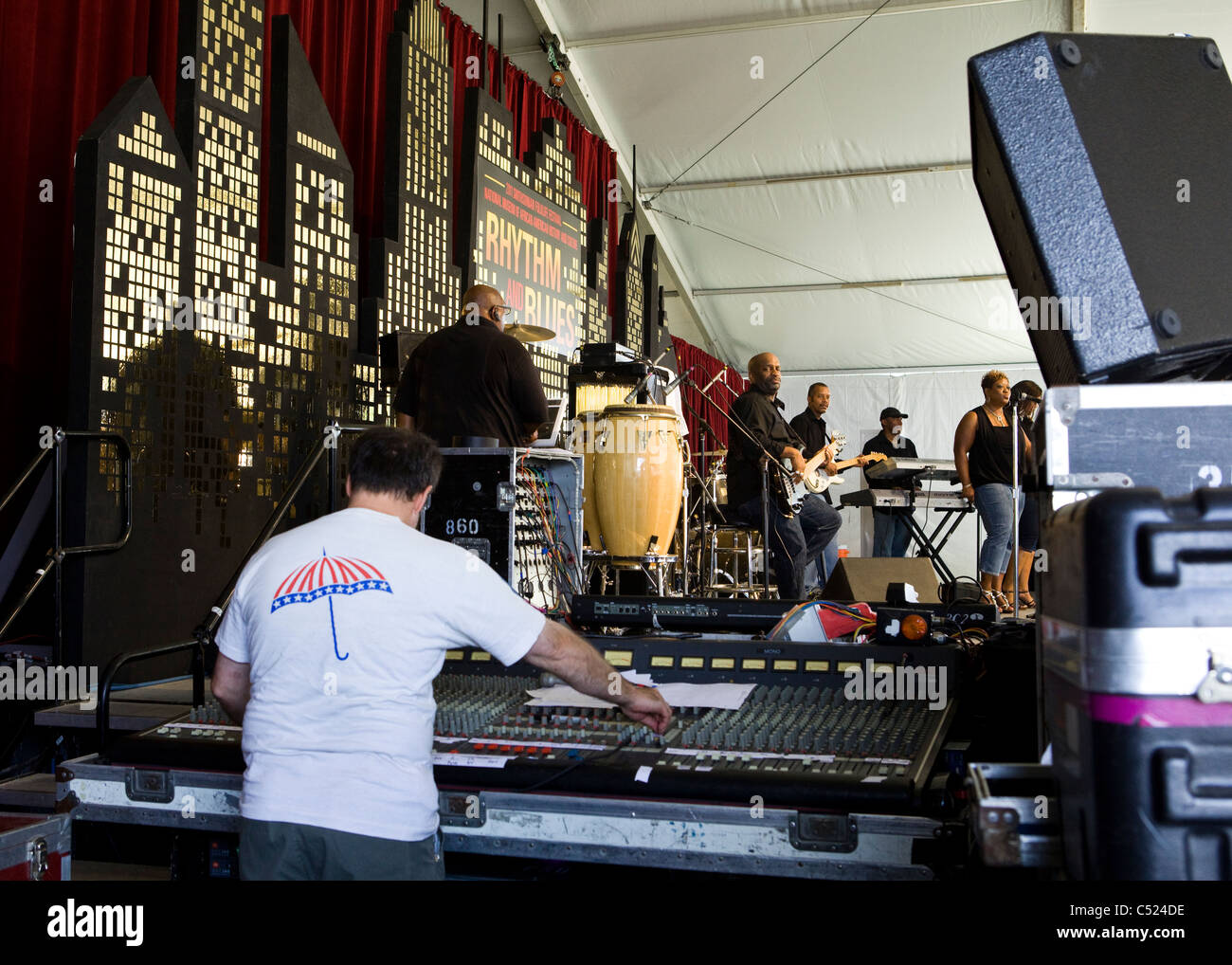 Audio engineer using a mixer next to stage - USA Stock Photo