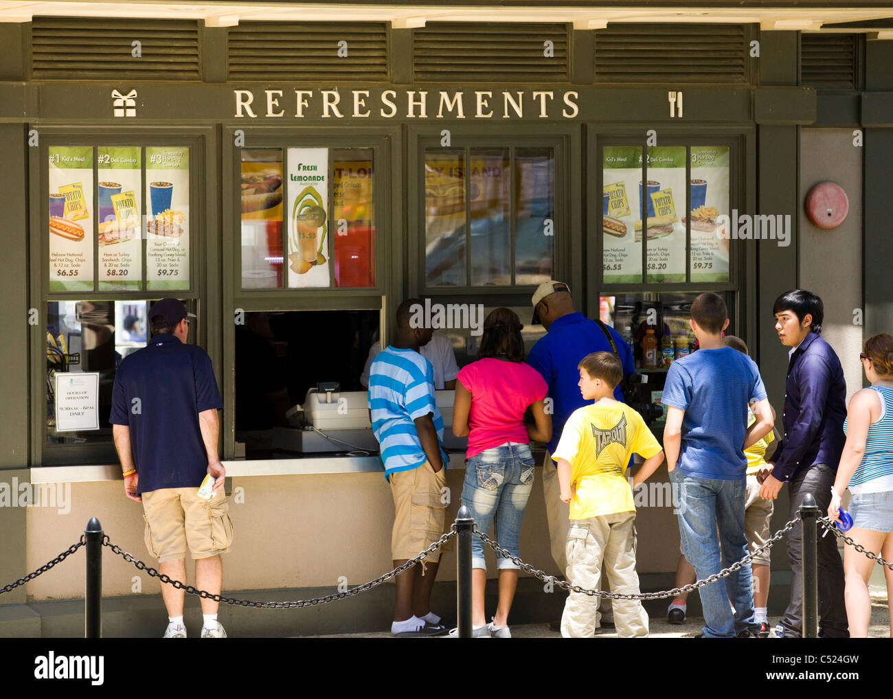 Patrons standing in queue at the concession stand Stock Photo