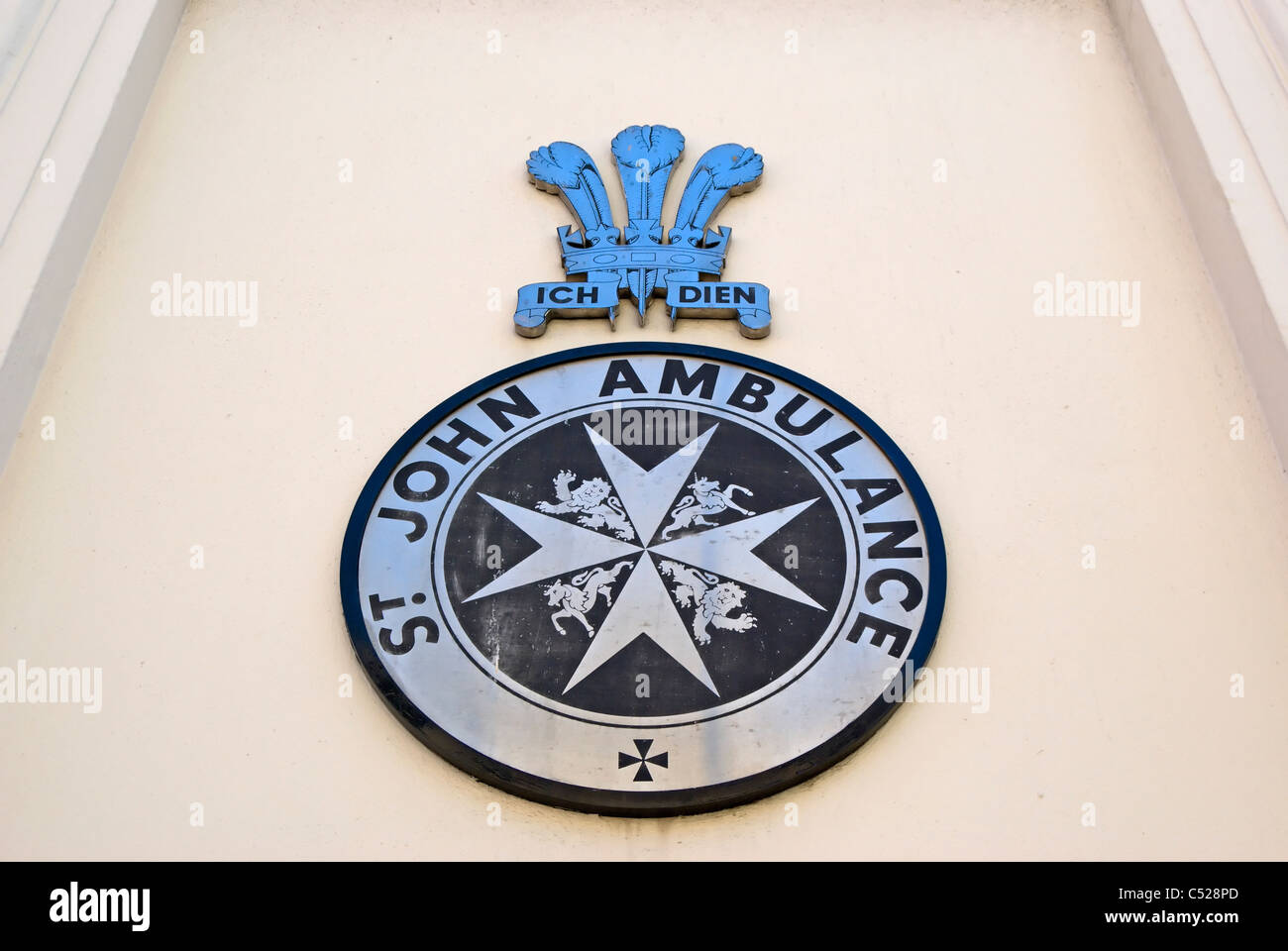 st john ambulance service logo beneath prince of wales feathers with motto 'ich dien', or 'I serve' Stock Photo