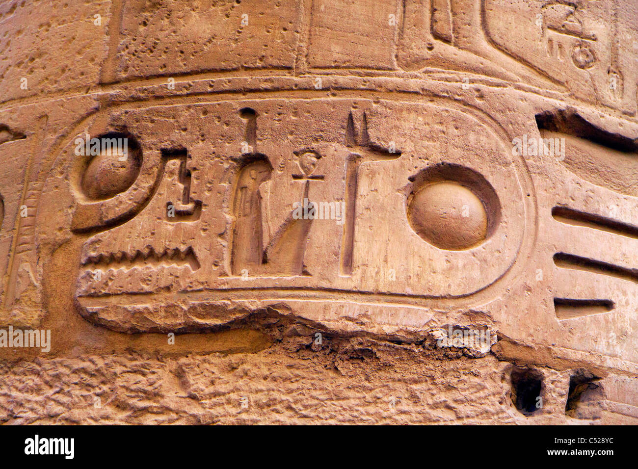 The supporting columns of the Hypostyle Hall in Karnak Temple. The columns are decorated with carvings of cult scenes. Stock Photo