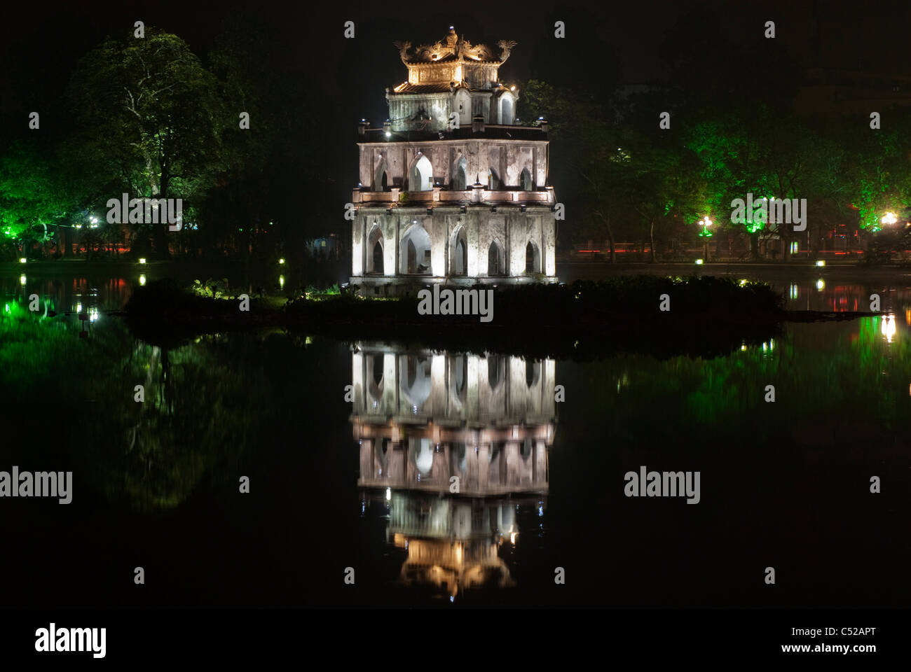 The historic Tortoise Tower, Thap Rua, reflected in Hoan Kiem Lake at night, Hanoi, Vietnam Stock Photo