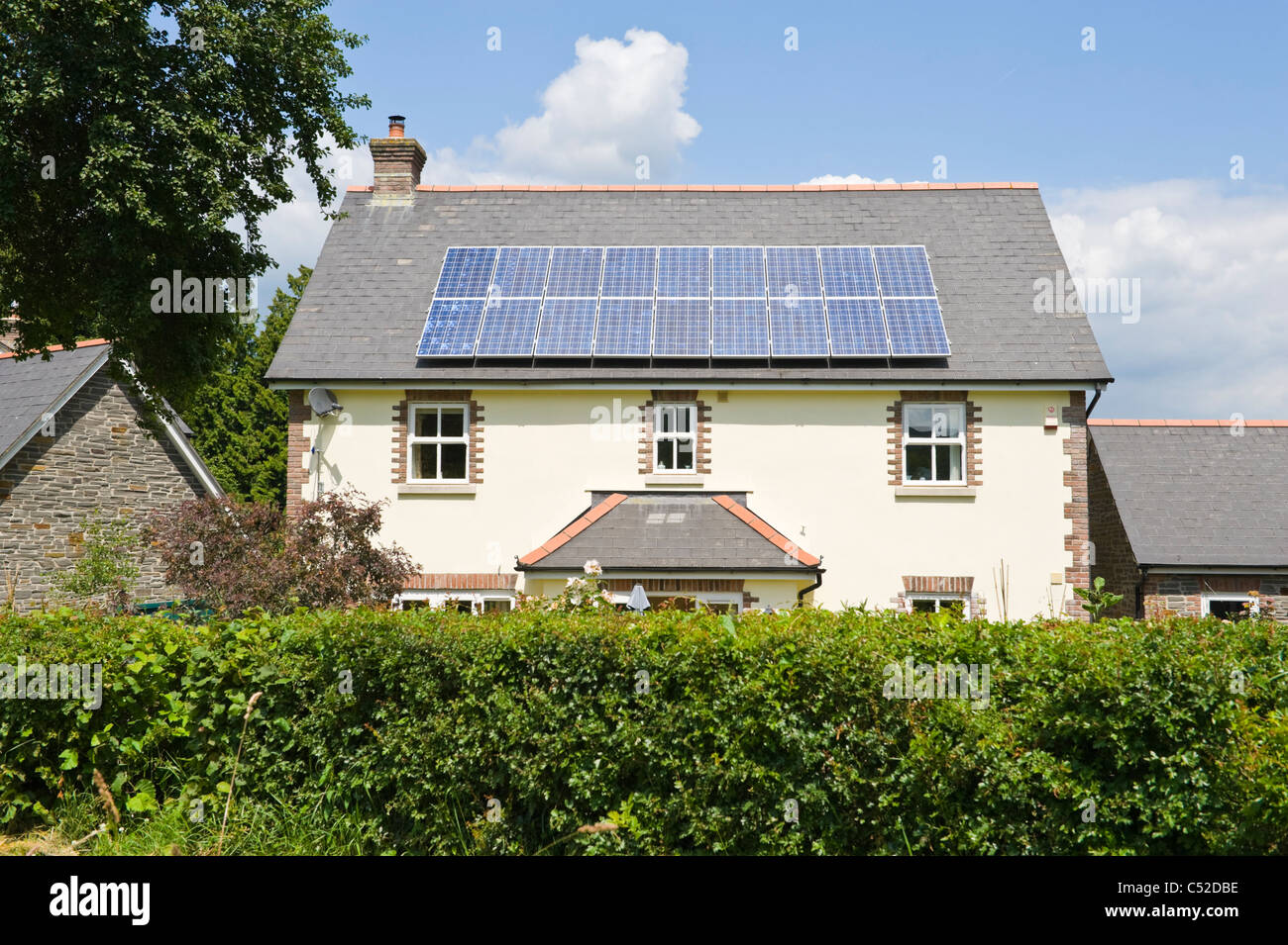 Solar panels on roof of detached house in village of Llangattock Powys South Wales UK Stock