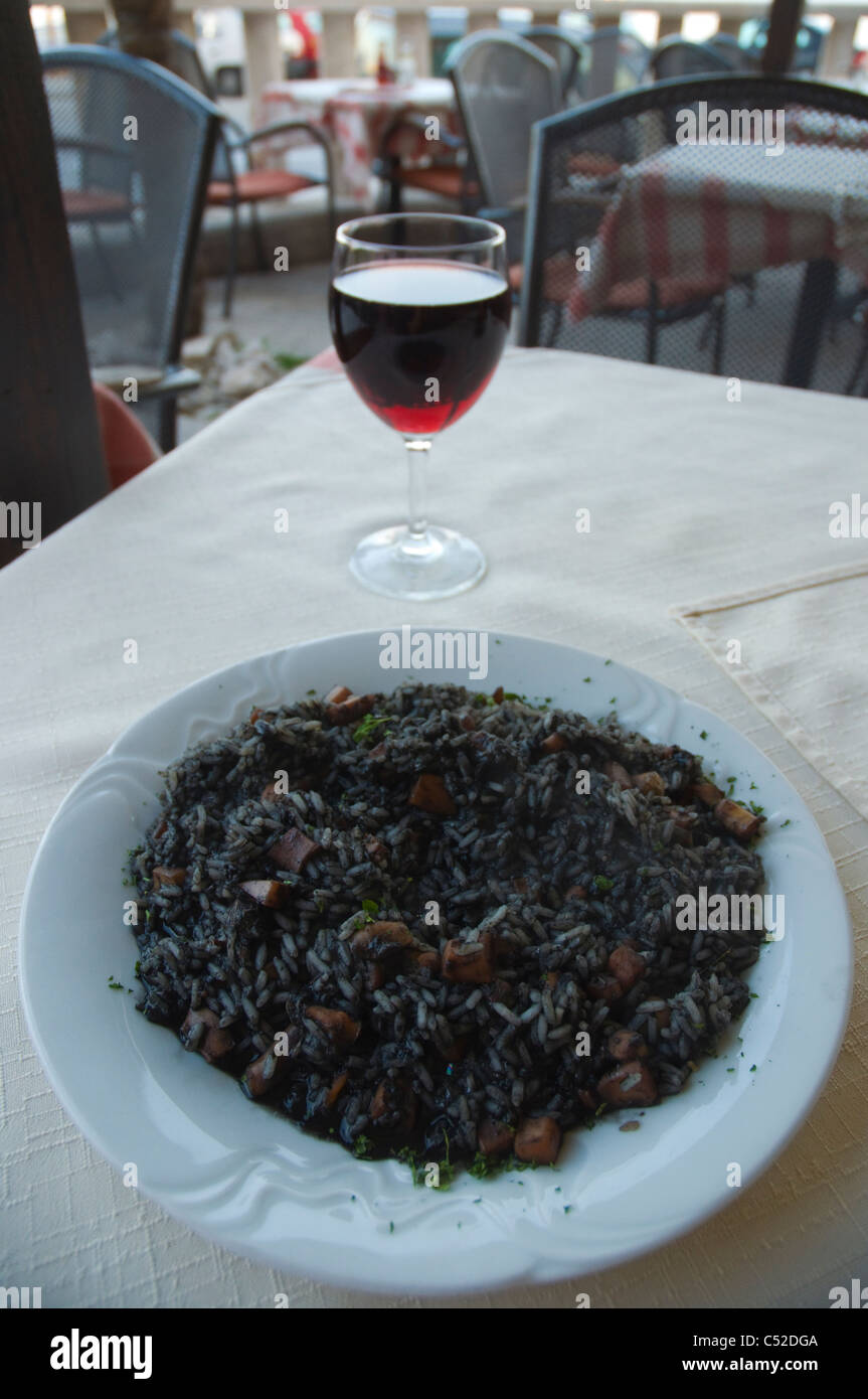 Risotto Nero the black seafood risotto and glass of red house wine